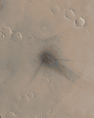 Colorized view of the impact site; a small crater at center of dark, extensive rays, with longest rays pointing toward the southeast.